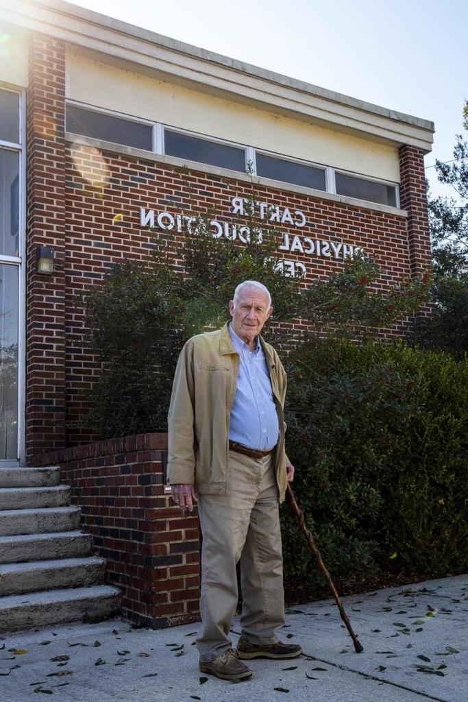 Rep Carter in front of Carter Gymnasium